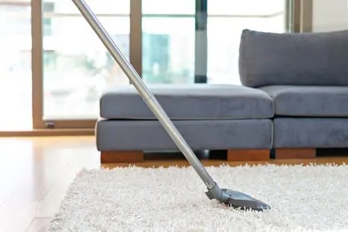 Mopping the floor of a bright, freshly cleaned living room